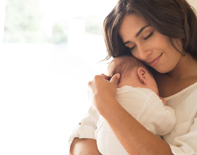 mother holding baby