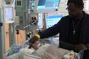 Man-Holding-His-Baby-Inside-Incubator