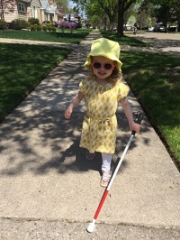 girl walking with blind cane