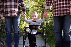 Conner Walker holding parents' hands