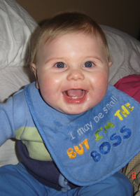 smiling baby boy with bib